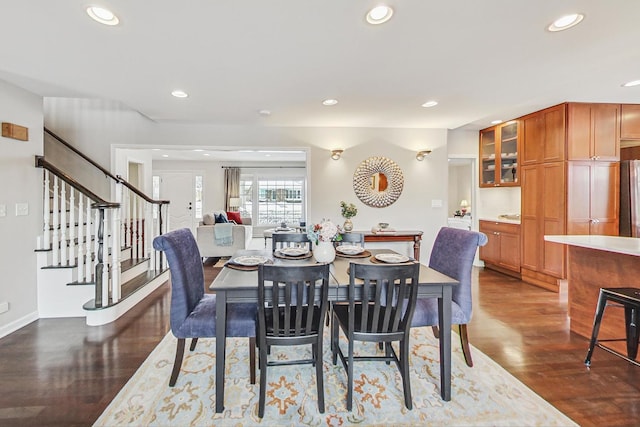 dining space featuring stairway, dark wood-style flooring, and recessed lighting