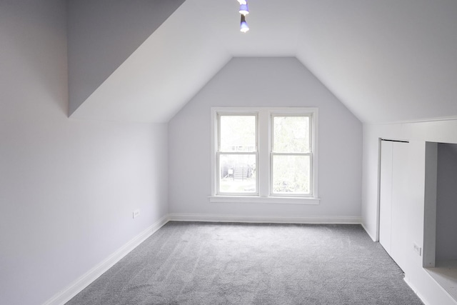 bonus room featuring lofted ceiling and carpet floors