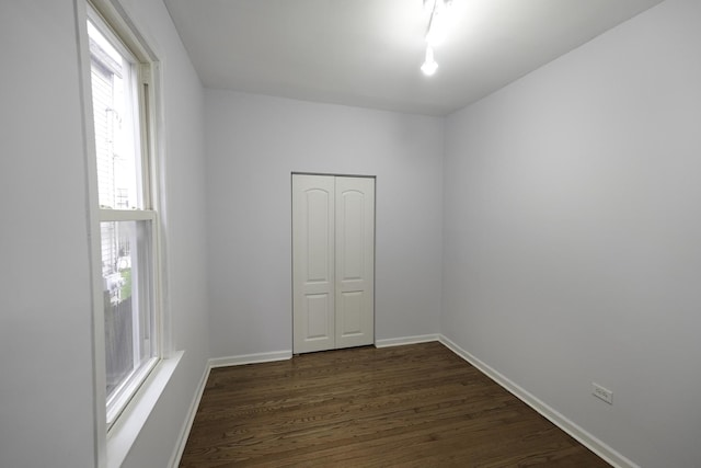 unfurnished room featuring dark hardwood / wood-style flooring