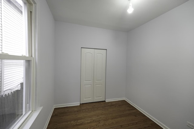 empty room featuring dark wood-type flooring