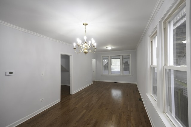 unfurnished dining area with ornamental molding, dark wood-type flooring, and a chandelier