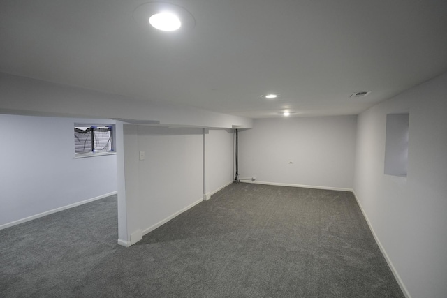 basement featuring dark carpet