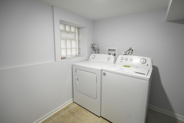 clothes washing area featuring light tile patterned flooring and independent washer and dryer