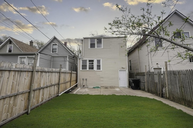 rear view of house featuring a yard and a patio area