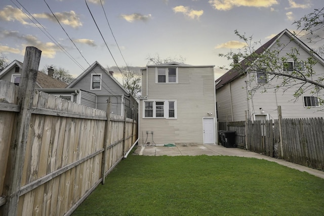 back of house with a yard and a patio area