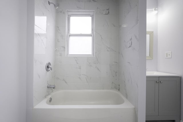 bathroom with vanity and tiled shower / bath