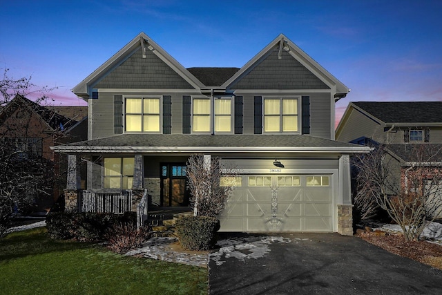 view of front of property featuring a porch and a garage