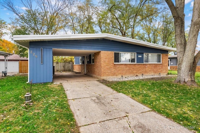 exterior space featuring a carport and a front lawn