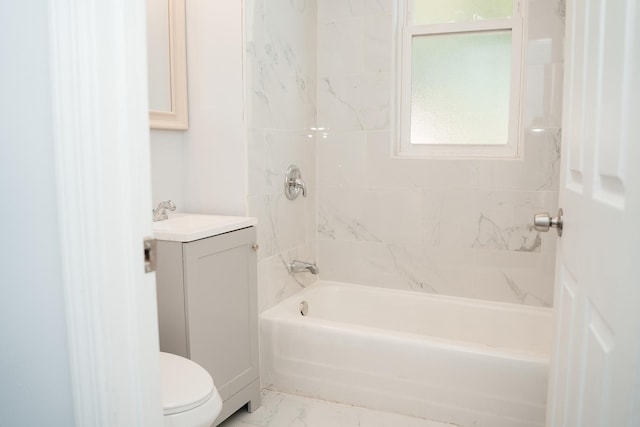 full bathroom featuring tiled shower / bath combo, vanity, and toilet