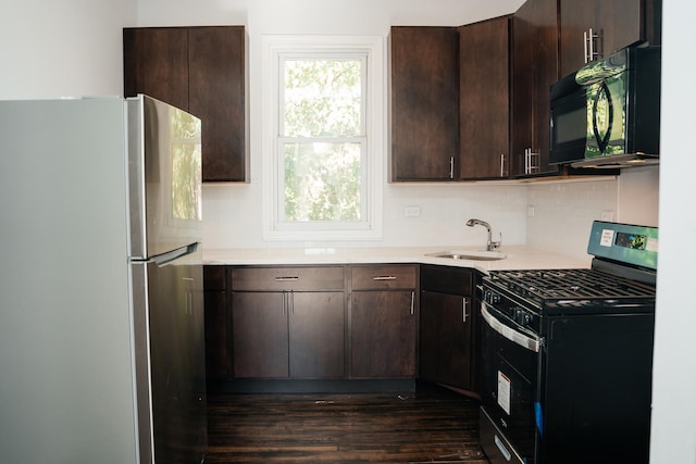 kitchen featuring stainless steel appliances, dark brown cabinets, and sink