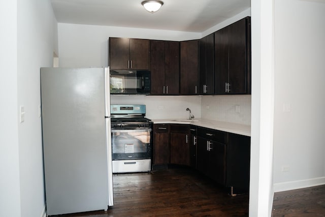 kitchen featuring sink, backsplash, dark hardwood / wood-style flooring, stainless steel appliances, and dark brown cabinets