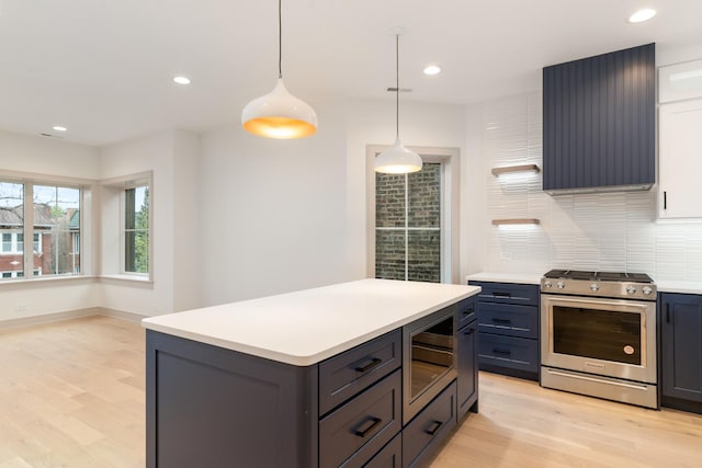 kitchen with tasteful backsplash, decorative light fixtures, a center island, light hardwood / wood-style flooring, and stainless steel appliances