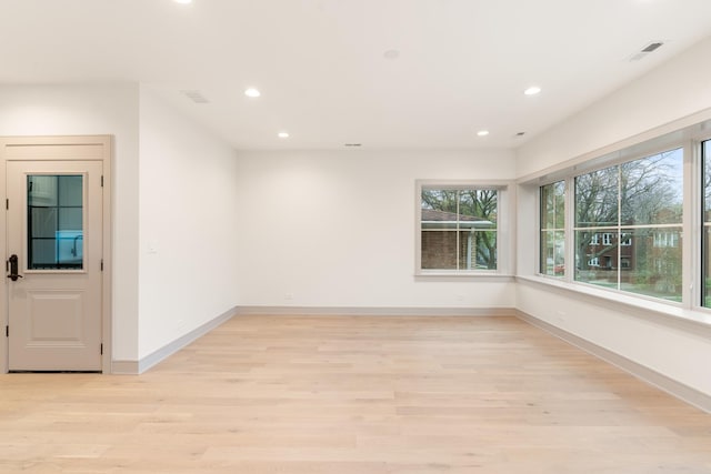 spare room with light hardwood / wood-style floors