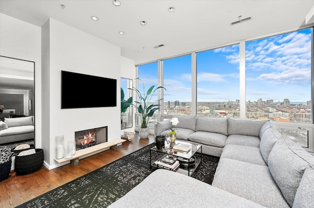 living room featuring hardwood / wood-style flooring and a wall of windows