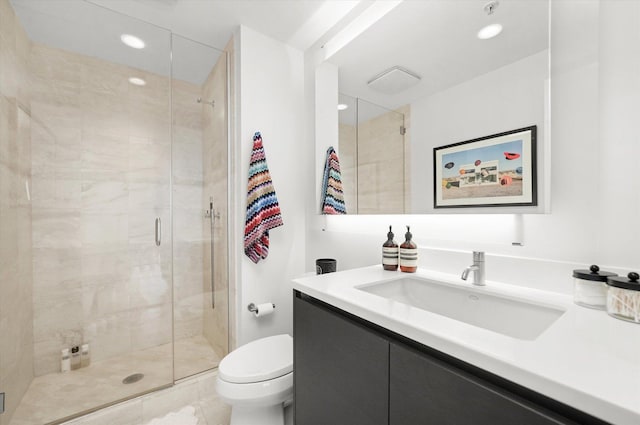 bathroom featuring vanity, toilet, and walk in shower