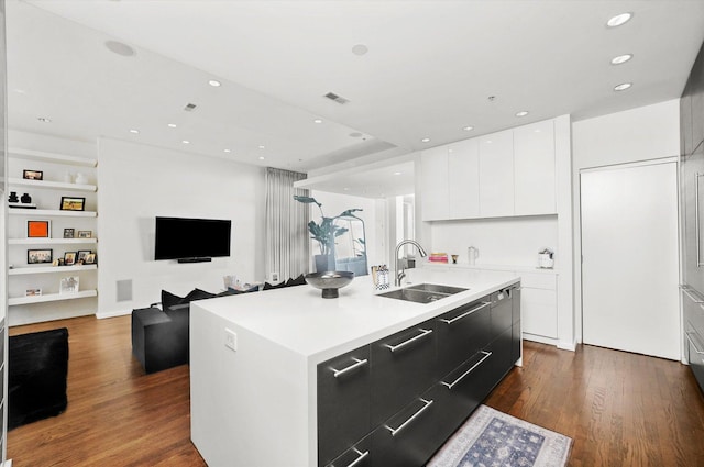 kitchen featuring white cabinetry, sink, dark hardwood / wood-style flooring, and a kitchen island with sink