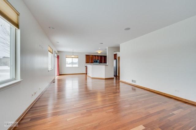 unfurnished living room with light wood-type flooring