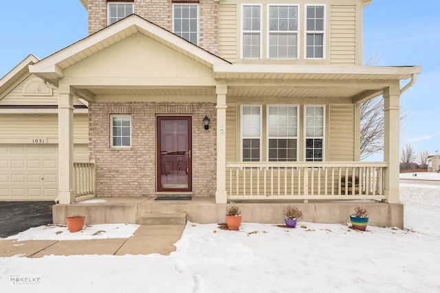 view of front of property with a garage and a porch