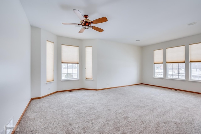 unfurnished room featuring ceiling fan and carpet