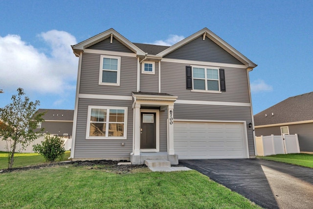 view of front of property featuring a garage and a front lawn