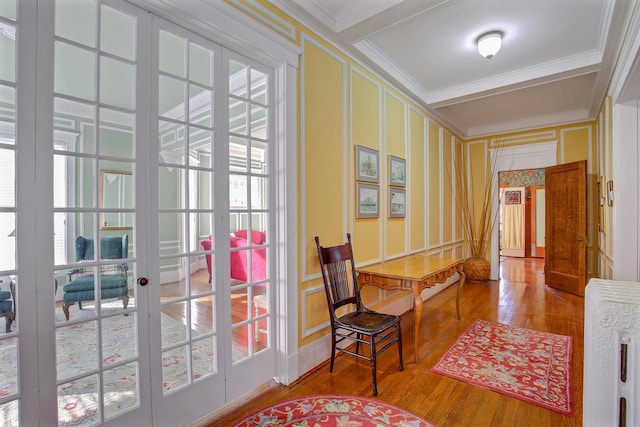 interior space with crown molding, a healthy amount of sunlight, and hardwood / wood-style flooring