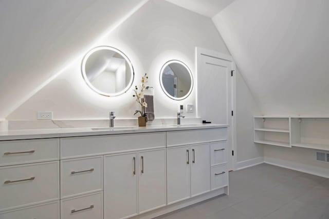 bathroom featuring vanity and vaulted ceiling