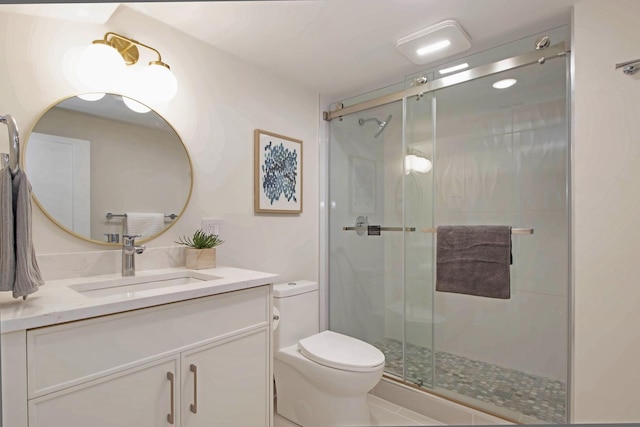 bathroom featuring walk in shower, vanity, and toilet