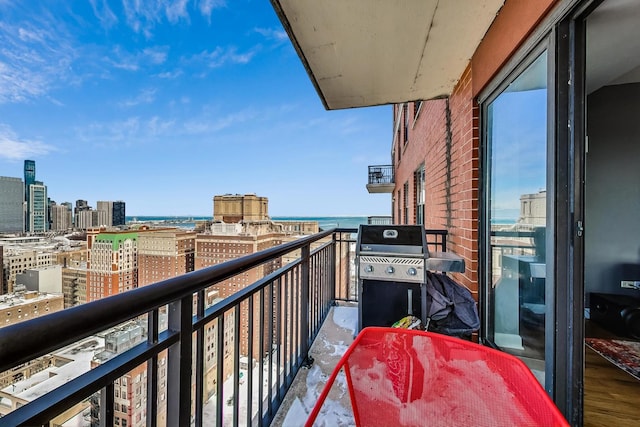 balcony featuring a view of city, a water view, and area for grilling