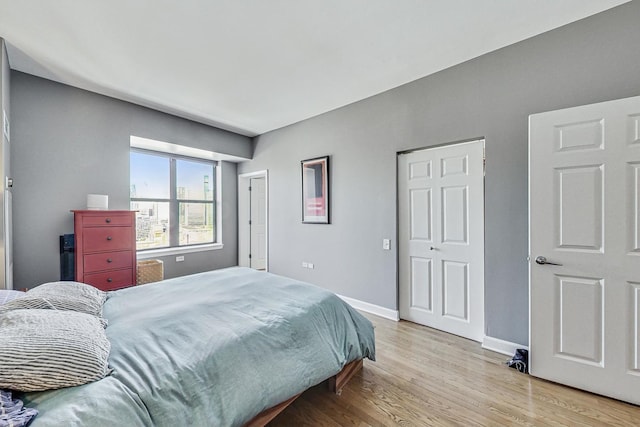 bedroom featuring light wood-type flooring and baseboards