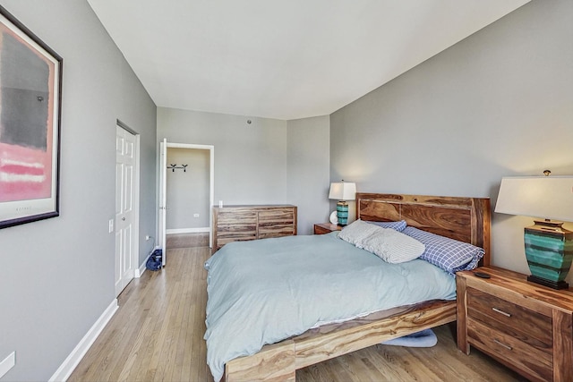 bedroom with light wood-style flooring and baseboards