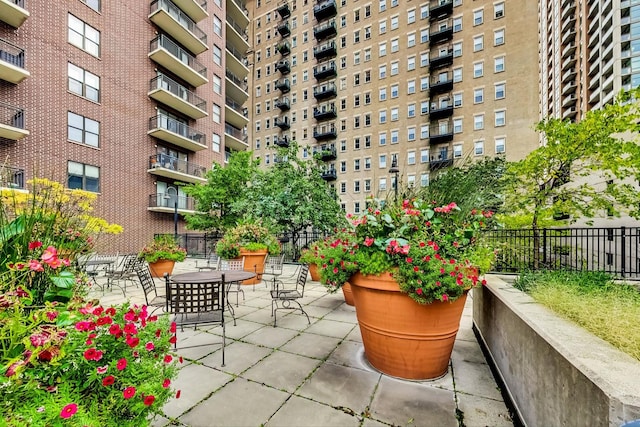 view of community with a patio and fence