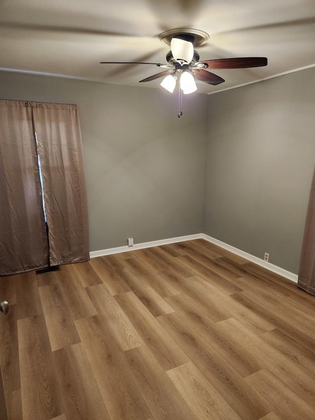 empty room featuring hardwood / wood-style flooring and ceiling fan