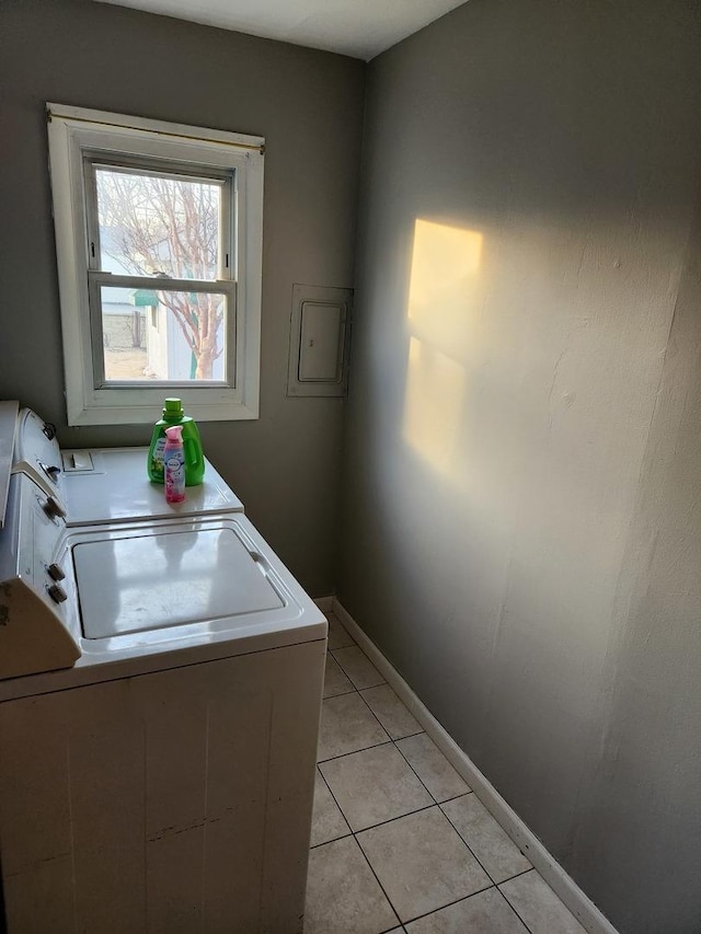 laundry room featuring independent washer and dryer and light tile patterned flooring