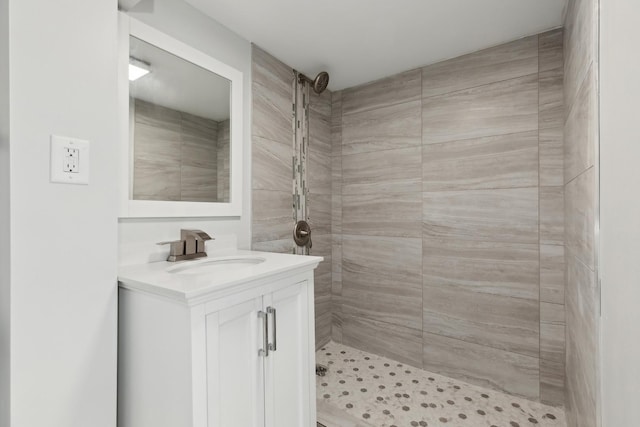 bathroom featuring a shower stall and vanity