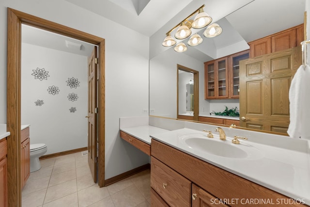 bathroom featuring tile patterned flooring, vanity, and toilet