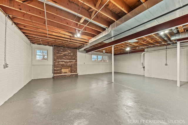 basement with brick wall and plenty of natural light