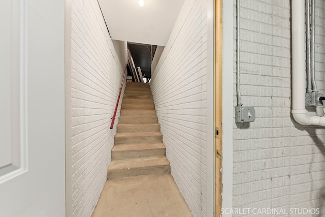 staircase with brick wall