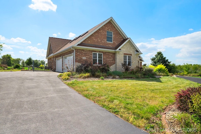 view of front of property featuring a garage and a front yard