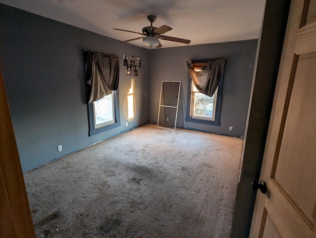 unfurnished room featuring light colored carpet and ceiling fan