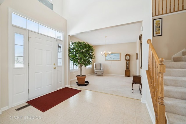 foyer featuring a high ceiling and an inviting chandelier