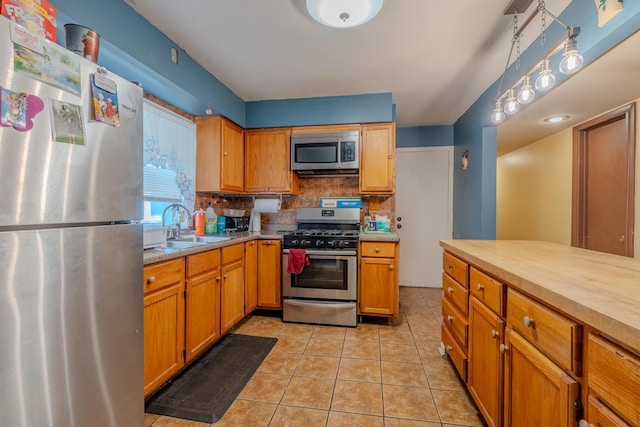 5309 S 72nd Ct, Summit, IL 60501 - kitchen with stainless steel appliances, backsplash, light tile patterned flooring, and brown cabinetry
