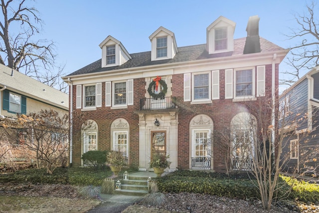 colonial-style house with brick siding