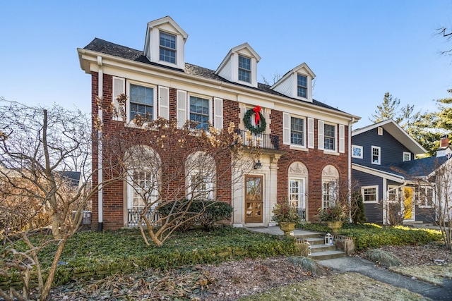 georgian-style home with brick siding