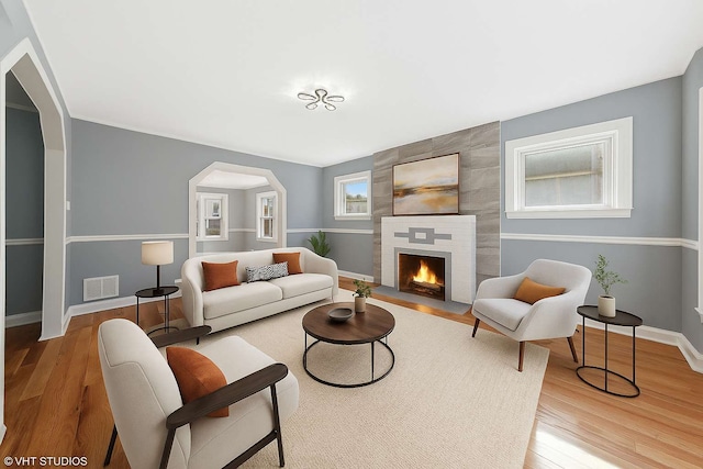 7121 S Yale Ave, Chicago, IL 60621 - living room with wood finished floors, a tile fireplace, and arched walkways