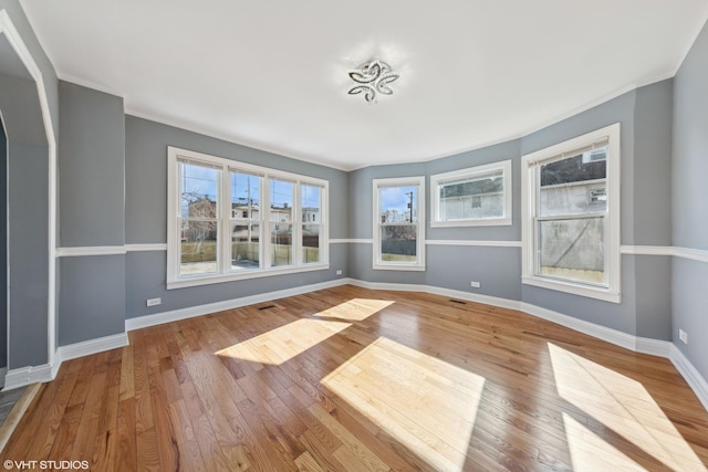 7121 S Yale Ave, Chicago, IL 60621 - unfurnished living room featuring healthy amount of natural light, wood finished floors, and ornamental molding