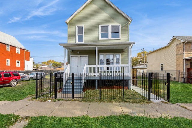 view of front of home featuring a porch, a fenced front yard, a front lawn, and a gate