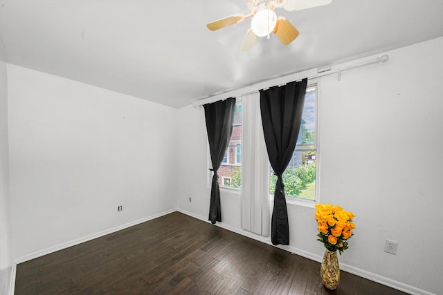 spare room with dark hardwood / wood-style floors and ceiling fan