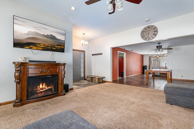 carpeted living room featuring ceiling fan