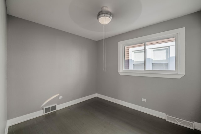 spare room featuring ceiling fan and dark hardwood / wood-style flooring