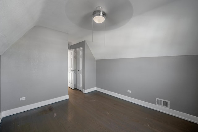 additional living space with vaulted ceiling, dark hardwood / wood-style floors, and ceiling fan